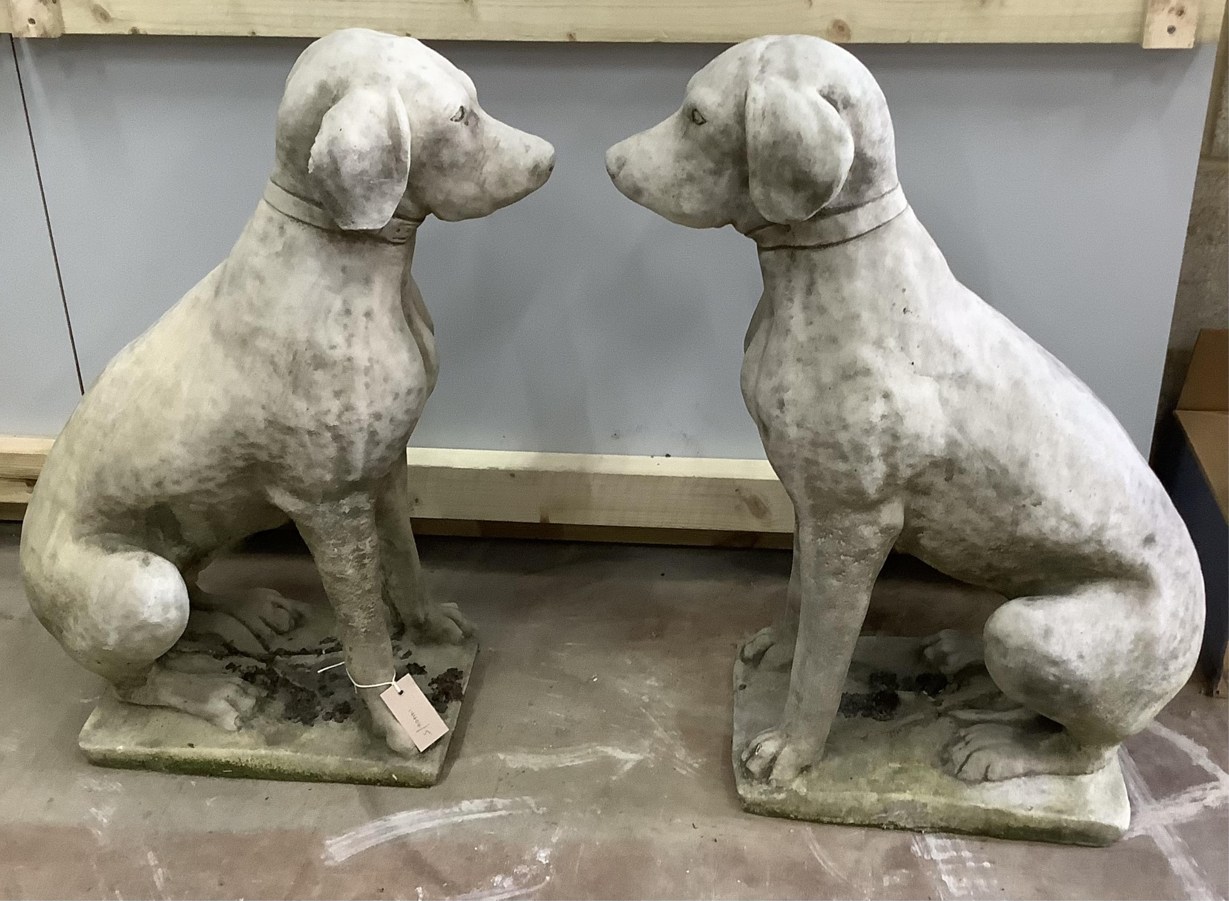 A pair of reconstituted stone seated hound garden ornaments, height 71cm